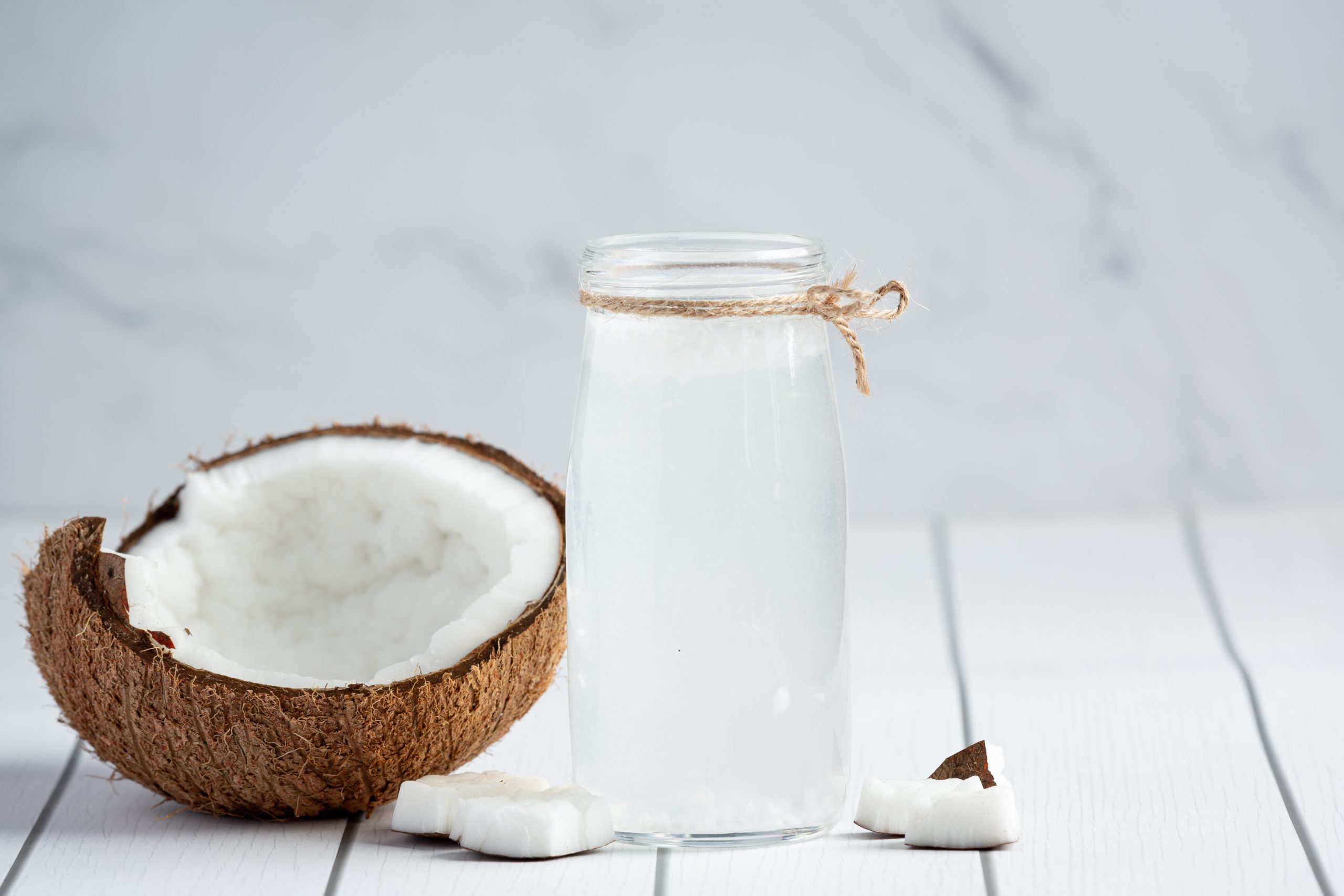 glass-coconut-water-put-white-wooden-background (1)